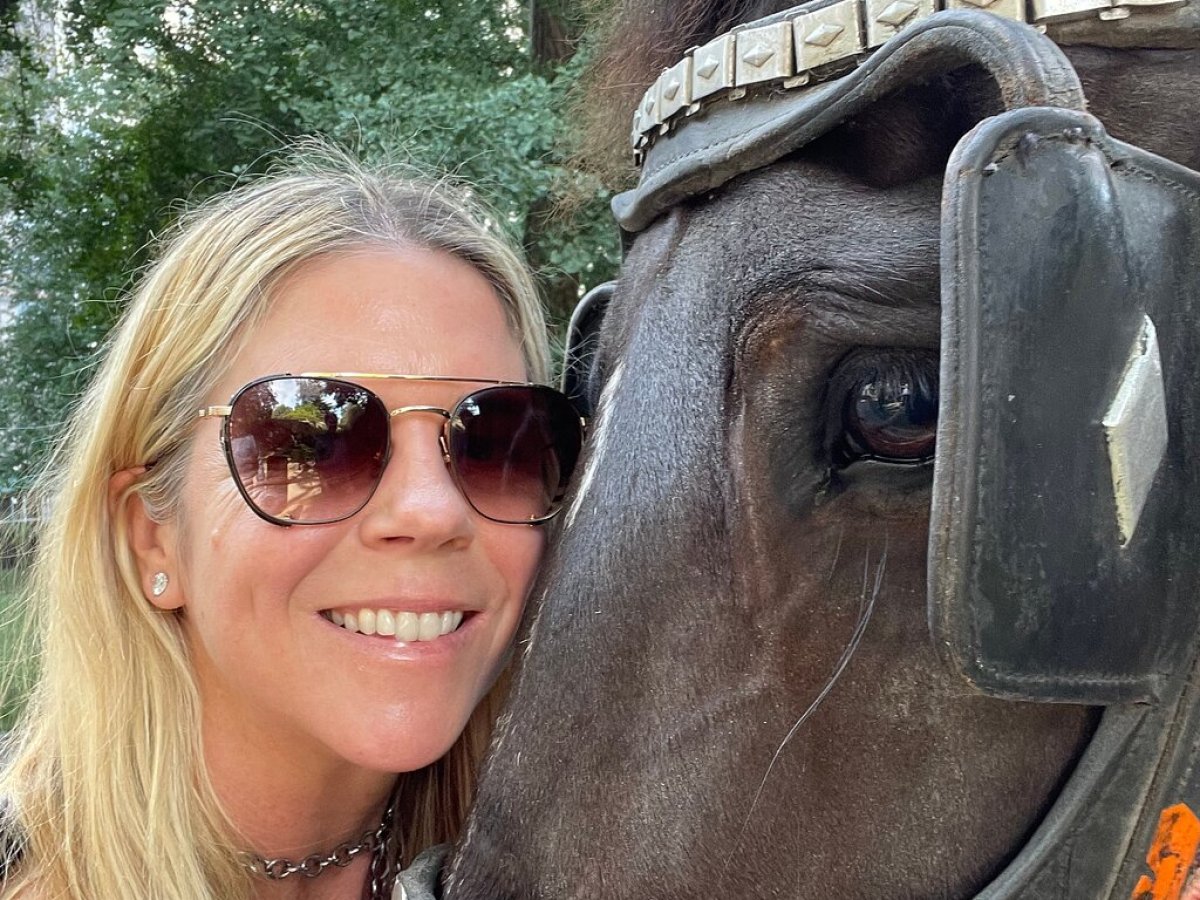 a woman wearing sunglasses posing for the camera