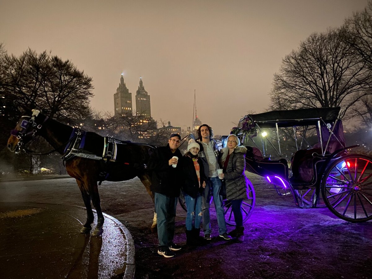 a group of people standing next to a horse