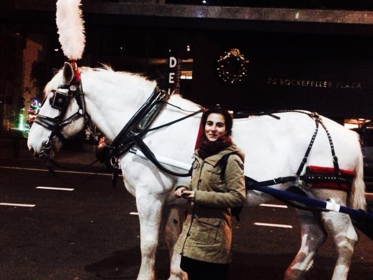a person riding a horse in front of a building