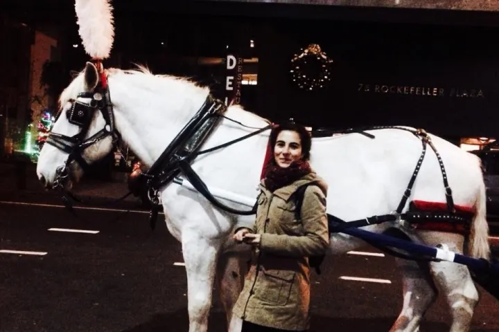 a person riding a horse in front of a building