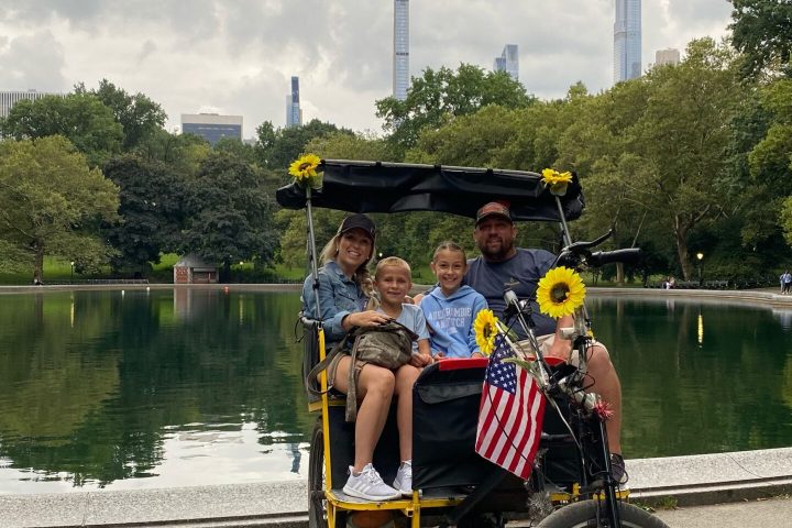 a man riding a bicycle next to a lake