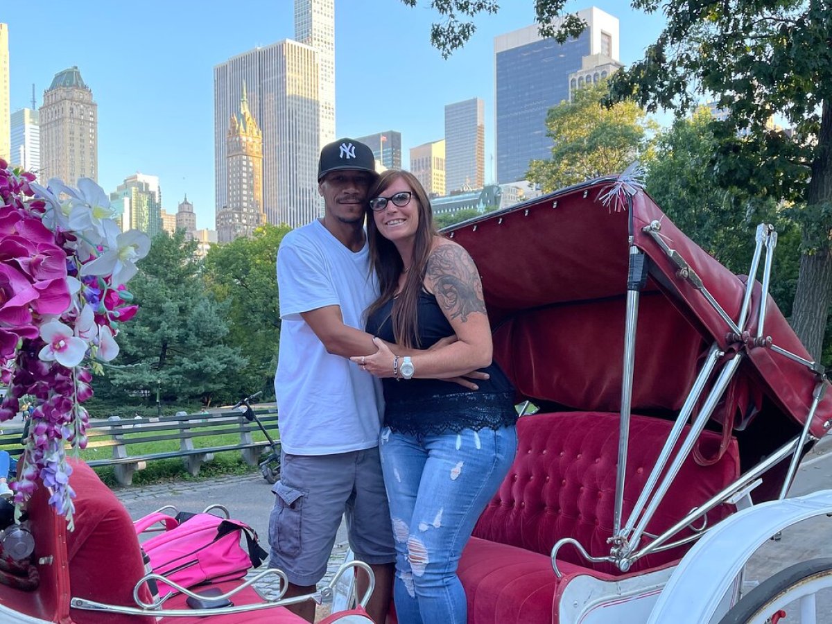 a man and a woman standing in front of a building